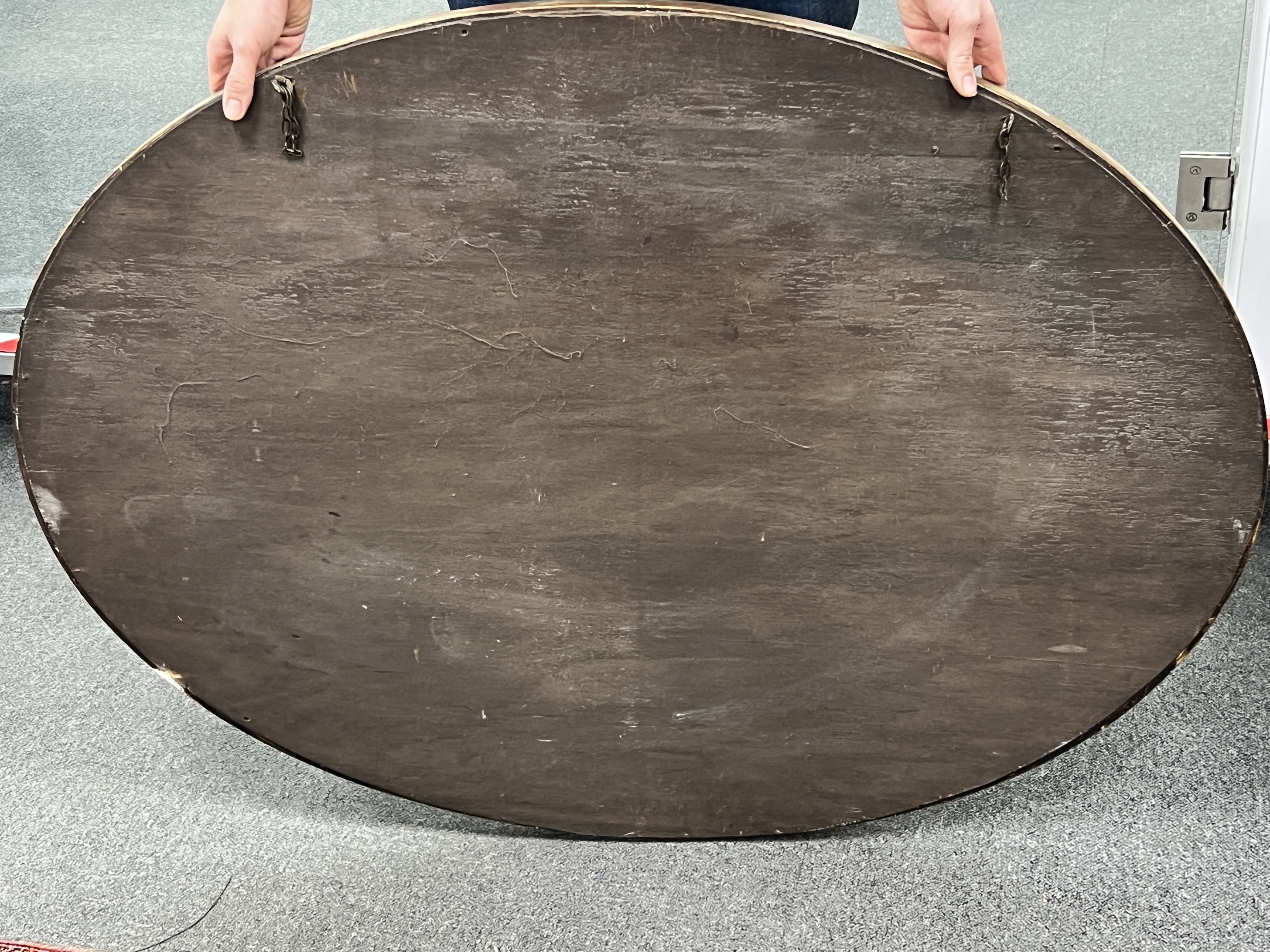 An oval giltwood and composition marginal plate wall mirror, width 113cm, height 83cm
